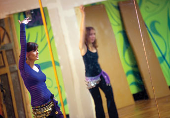 Leaf Ashley, left, leads Shannon Ardaiolo in a belly dancing session on Friday in Gallup. © 2011 Gallup Independent / Adron Gardner 